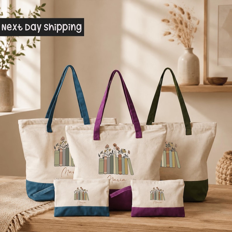 a collection of colorful tote bags and small bags with illustrations of books, arranged on a wooden surface.