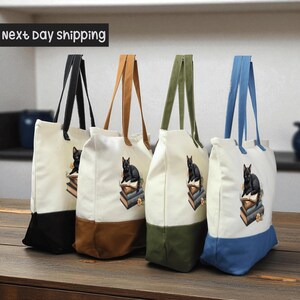 a collection of four tote bags, each with a different color and design, arranged on a wooden surface.