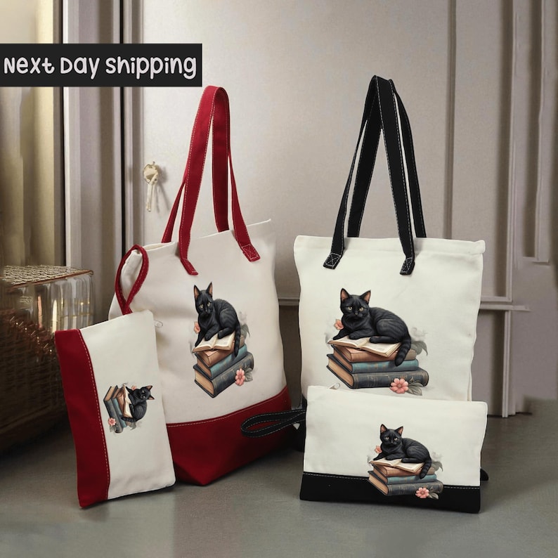 a collection of bags and accessories, including a red and white tote bag, a white tote bag, and a small white bag with a black cat design.