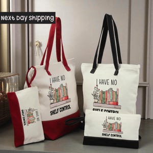 a collection of four bags, including a red and white tote bag, a white tote bag, a small red and white bag, and a small black bag, all with the same design and text printed on them.