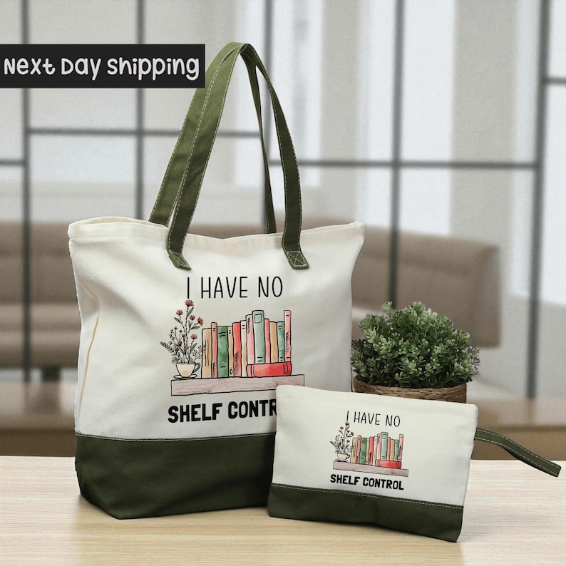 A large white tote bag with a printed design and text, and a smaller white bag with a similar design and text, both placed on a wooden surface.