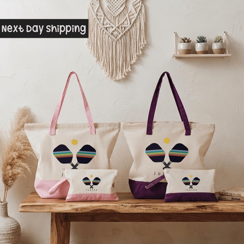 a collection of colorful tote bags and a small bag set, arranged on a wooden surface against a white wall.