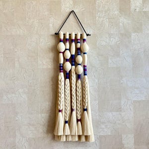 Macrame wall hanging made of cotton rope in purple and navy blue
