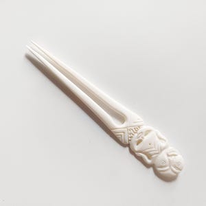 Bone hair stick 2 Prong , carved Hei Tiki carved figure bone hair fork