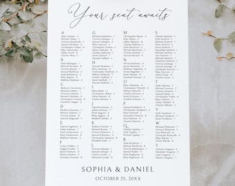 May include: A white seating chart with the text "Your seat awaits" in elegant script. The chart lists names alphabetically, with "Sophia & Daniel" and the date at the bottom. It is displayed on a wooden easel.