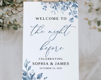 May include: Welcome to the night before sign with blue watercolor floral design. Celebrating Sophia & James, October 23, 2026.