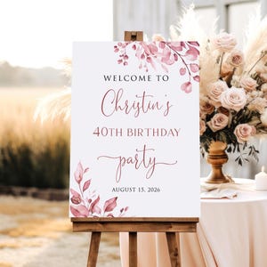 May include: Welcome to Christin's 40th Birthday party, 15 August 2026. A white sign with pink floral watercolour design and calligraphy text.