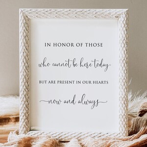 May include: A framed print with the text "IN HONOR OF THOSE who cannot be here today. BUT ARE PRESENT IN OUR HEARTS now and always." The frame is white with a textured pattern. The text is in black script.