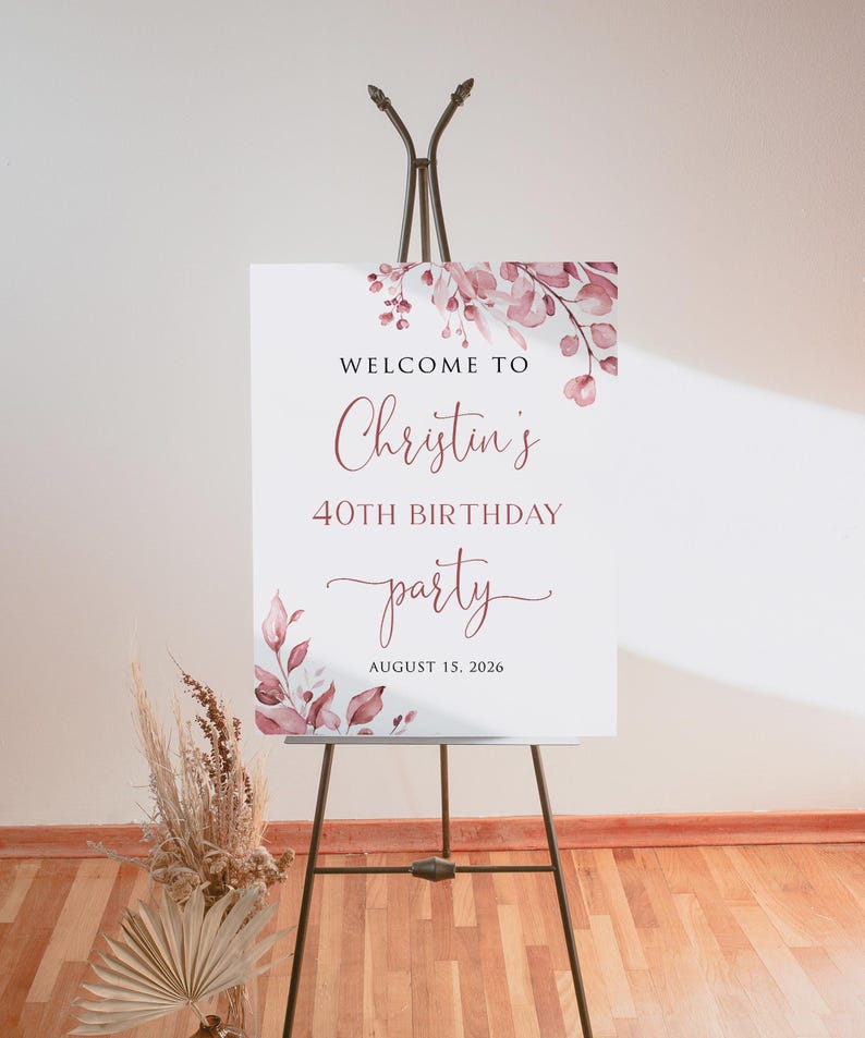 May include: Welcome to Christina's 40th Birthday party, 15 August 2026. A white sign with pink floral watercolour design and calligraphy text.