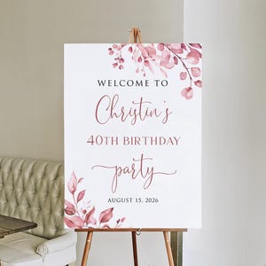 May include: Welcome to Christin's 40th Birthday party, 15 August 2026. A white sign with pink floral watercolour design.