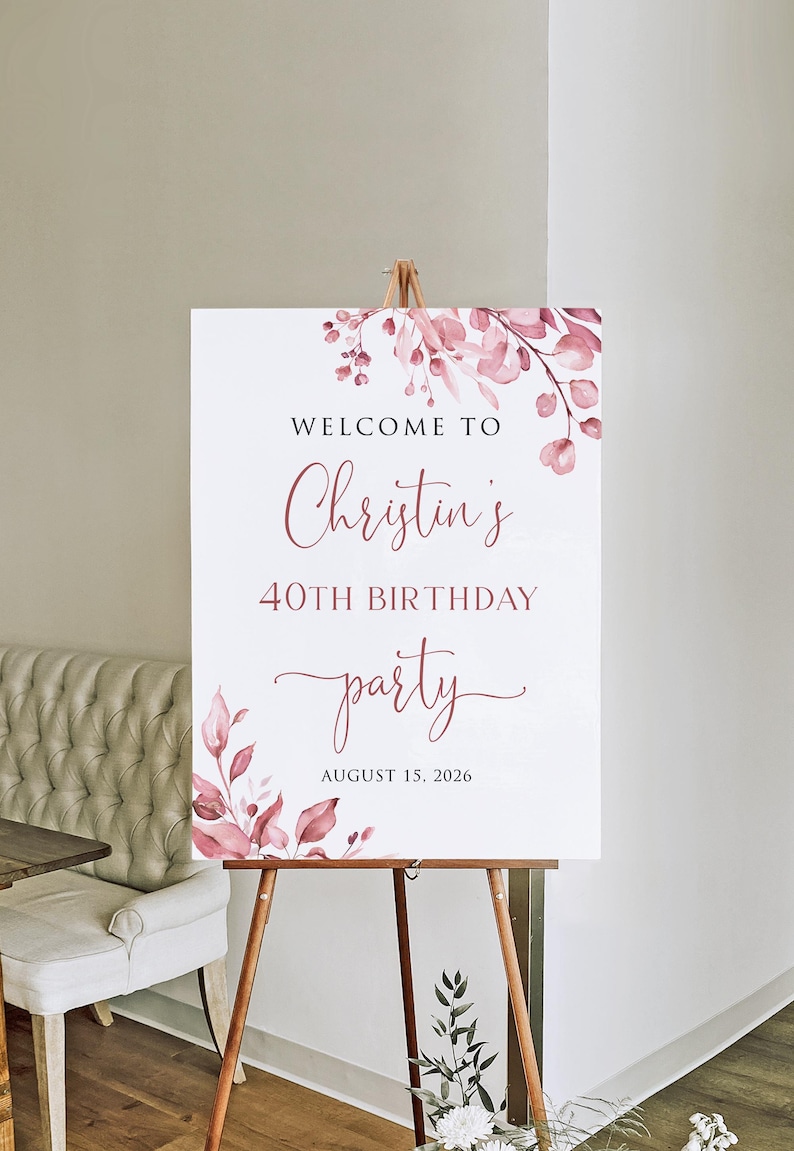 May include: Welcome to Christin's 40th Birthday party, 15 August 2026. A white sign with pink floral watercolour design.