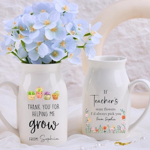 May include: Two white ceramic vases with handles, one filled with blue flowers. The first vase has the text "THANK YOU FOR HELPING ME grow FROM: Sophia" and a succulent graphic. The second vase says "If Teacher's were flowers I'd always pick you From Sophia".