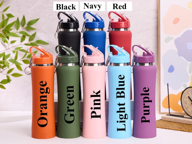 May include: A collection of insulated water bottles in various colors, including black, navy, red, orange, green, pink, light blue, and purple. Each bottle has a matching lid and a carabiner clip for easy carrying.
