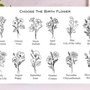 May include: A white print featuring twelve floral illustrations, each representing a birth month flower. The text "CHOOSE THE BIRTH FLOWER" is at the top. Flowers include carnation, violet, daffodil, daisy, lily of the valley, rose, water lily, poppy, aster, cosmos, chrysanthemum, and holly.