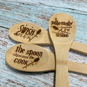 May include: Three wooden spoons with engraved text. The first spoon says "Swish & Flick". The second spoon says "I solemnly swear I'm up to no good". The third spoon says "The spoon chooses the cook".