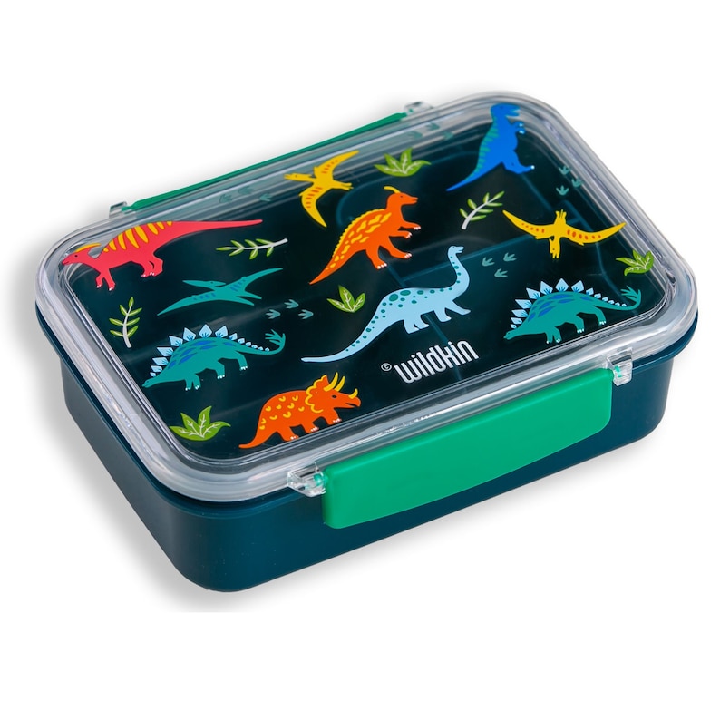 May include: A green lunchbox with a clear lid featuring a dinosaur pattern. The lid has a green handle and the words "Wildkin" are printed on the lid.