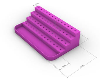 May include: A magenta-colored tiered organizer with multiple rows of small holes, likely for holding items. The design includes a rectangular base with a curved edge and a series of stepped platforms. Dimensions are indicated with lines and numbers.