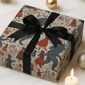 May include: A wrapped gift box with patterned paper featuring figures in red coats and blue creatures. The box is tied with a black satin ribbon and bow. Festive decorations, including candles and ornaments, surround the gift.
