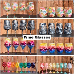 May include: A selection of colourful wine glasses with distinctive, abstract patterns. The glasses showcase a range of vivid colours, such as pink, yellow, blue, and green, forming an attractive arrangement. The text "Wine Glasses" is displayed in white.