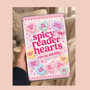May include: A clear tablet case with a pink and white design featuring the text "spicy reader hearts" and various heart-shaped candies with phrases like "Read Me" and "Fake Date". The case is decorated with hearts and stars.