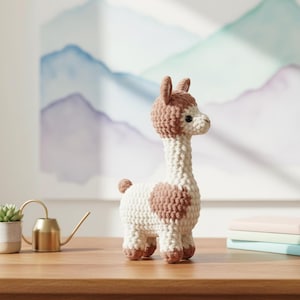 May include: A handmade crochet llama figurine in white and brown. The llama has a long neck, small ears, and a rounded body with brown spots. It stands on four legs and has a small tail. The llama is a decorative item.