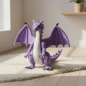 May include: A large, handmade crochet dragon in shades of purple and white. The dragon has outstretched wings, a long neck, and a detailed tail. The dragon is standing on a cream-colored rug, with a wooden floor in the background.