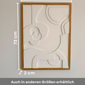 Abstraktes Wandrelief mit geöltem Eichenholzrahmen im Format 73 x 54 x 2 cm – auch in weiteren Größen mit identischem Design erhältlich. Gefertigt aus CNC-gefrästem MDF mit strukturierter Oberfläche in Cremeweiß, verbindet das 3D Wandbild minimalistisches Design mit natürlicher Ästhetik. Ideal als moderne Wanddeko für Wohnzimmer, Flur oder Büro im Japandi-, Skandi- oder modernen Stil. Hochwertige Handarbeit und vielseitig kombinierbar.