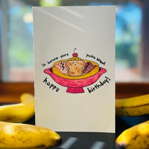 "Bananenbrot-Split ""In Banana Year's You're Bread"" Geburtstagskarte."