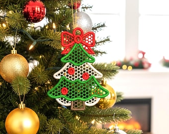 May include: A Christmas tree ornament in the shape of a tree with a red bow at the top. The tree is green and white with red accents. The ornament is hanging on a Christmas tree with other ornaments.