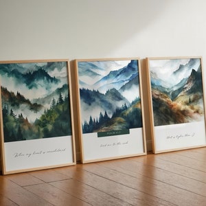 May include: Three framed watercolour paintings of misty mountain landscapes. The top left painting has the text "When my heart is overwhelmed". The top right painting has the text "PSALM 42:12" and "Lead me to the rock". The bottom right painting has the text "that is higher than I".