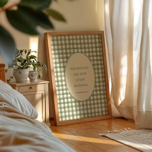 May include: A rectangular framed wall art piece featuring a sage green and white gingham check pattern. In the center, an oval cream-colored plaque displays the text: HIS MERCIES ARE NEW EVERY MORNING. Lamentations 3:23 in dark lettering.