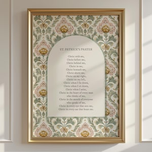 May include: A framed print of St. Patrick's Prayer. The text is within an arched white space, surrounded by a floral pattern in pink, green, and gold. The gold frame adds a touch of elegance.