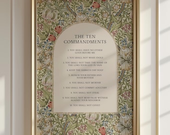 May include: A framed wall art print featuring The Ten Commandments in black text centered within an arched cream-colored panel. The background displays a dense botanical pattern of green leaves, vines, and red and blue flowers in a gold frame.