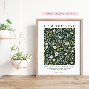 May include: A framed art print with a floral pattern in shades of green, cream, and gold against a dark background. The print includes the text "I AM THE VINE, YOU ARE THE BRANCHES" and "DOWNLOAD & PRINT". Two hanging planters with succulents are also visible.