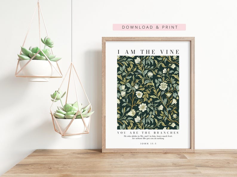 May include: A framed art print with a floral pattern in shades of green, cream, and gold against a dark background. The print includes the text "I AM THE VINE, YOU ARE THE BRANCHES" and "DOWNLOAD & PRINT". Two hanging planters with succulents are also visible.