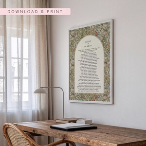 May include: A rectangular wall art print featuring the Litany of Humility prayer text centred within an arched cream-coloured panel. The border displays a dense, colourful floral and botanical pattern with green, red, and white elements.
