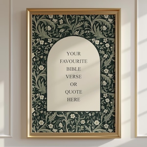 May include: A framed print with a gold border. The background features a dark green floral pattern. The centre has a cream-coloured arch with the text "YOUR FAVOURITE BIBLE VERSE OR QUOTE HERE".