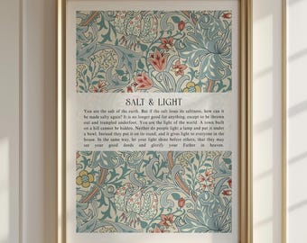 May include: A framed wall art print featuring a floral pattern in muted blue, red, and yellow tones. The center contains the text SALT & LIGHT followed by the biblical passage: You are the salt of the earth. But if the salt loses its saltiness...