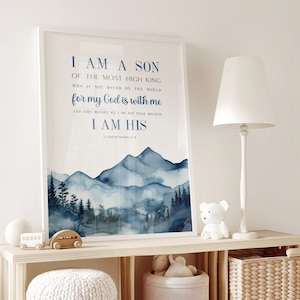 May include: A framed wall art print featuring a watercolour mountain landscape in shades of blue and white. The text reads: I AM A SON OF THE MOST HIGH KING WHO IS NOT MOVED BY THE WORLD for my God is with me AND GOES BEFORE ME I DO NOT FEAR BECAUSE I AM HIS 2 CORINTHIANS 6:18.