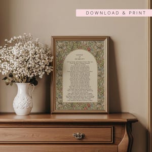 May include: A framed print featuring the Litany of Humility text centred within an arched cream-coloured panel, surrounded by a dense floral and leaf pattern in shades of green, red, and tan. The frame has a metallic gold finish.