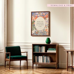 May include: A framed wall art print featuring a floral background with an oval center containing the text 'PRAISE GOD FROM WHOM ALL BLESSINGS FLOW'. The artwork is displayed above a wooden bookshelf filled with books and a green vase.