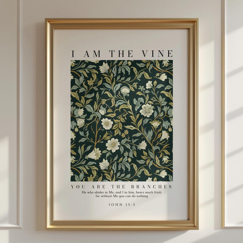 May include: A framed print with a gold-colored frame. The print features a dark green floral pattern with white and yellow flowers. The text "I AM THE VINE" is at the top, with "YOU ARE THE BRANCHES" below. The bottom text reads "JOHN 15:5".