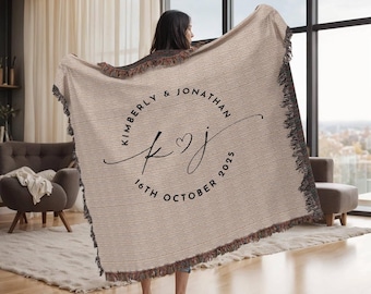 May include: Beige woven throw blanket with black fringe. The blanket features a circular design with the names "KIMBERLY & JONATHAN", initials "K J" with a heart, and the date "16TH OCTOBER 2025".