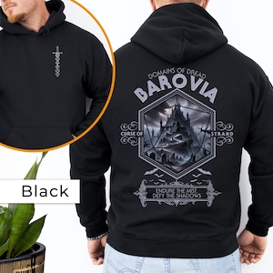 May include: Black hooded sweatshirt with a graphic print of a castle and the text "Domains of Dread Barovia Curse of Strahd Endure the Mist. Defy the Shadows".