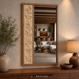 May include: A rectangular wall mirror with a wooden frame featuring a vertical column of six square beige stone tiles on the left side. Each tile displays a continuous carved leaf vine pattern. The text 4 BOTANIK is printed at the bottom.