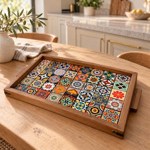 May include: A rectangular wooden serving tray featuring a mosaic of colourful square tiles. Each tile displays a unique, intricate floral or geometric pattern in shades of red, blue, yellow, green, and white. The tray has a natural wood frame.