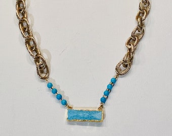 Shah. Turquoise and gold necklace on a chunky chain.