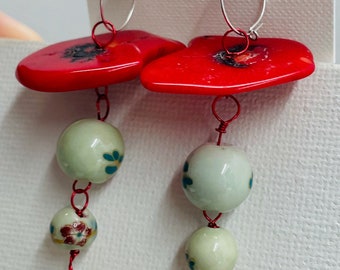 Red coral and ceramic dangling earrings.
