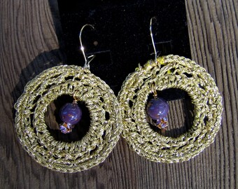 EDonut - Metallic gold thread crochet hoops featuring a purple and gold bead and a Swarovsky bead