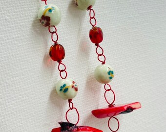 Red coral and ceramic dangling earrings.